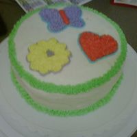 My First Cake This is a yellow cake with white buttercream frosting. I used a star tip for everything. Icing a cake is hard!!