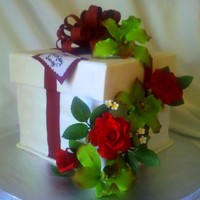 Orchids And Roses Chocolate cake with chocolate buttercream and toffee filling. Covered in vanilla fondant. Bow is fondant with tylose added and flowers are...