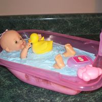 Bathtime Cake Baby tub and doll came from Walmart. I baked a yellow cake and cut in pieces to fit in the tub. Used blue homemade buttercream icing to...