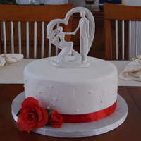 Small Wedding Cake This is a cake we did for a 12-15 person wedding. It features gumpaste roses, hand piping, and the topper was provided by the bride.