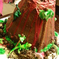 Volcano Cake this was my first volcano cake french vanilla cake in the inside and chocolate buttercream icing and ri for lava and the animals are toys...