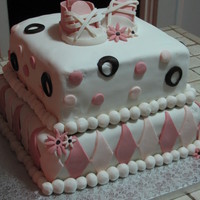 Beth's Baby Shower Cake Buttercream cake with fondant decorations and gumpaste baby converse. Bottom layer was chocolate fudge with chocolate mousse and top layer...