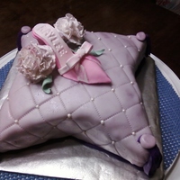 Kaylee 4Th Birthday This was my first pillow cake. I learned a lot. Covered with MMF and gumpaste shoe and flowers.