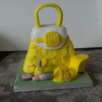 Bag And Shoe this is for 5 year old girl.madiera cake with buttercream filling.shoe and handle are made of gumpaste,lipstick and make up and the frills...