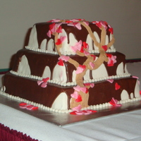 Love Blooms With Champagne And Chocolate Pink champagne flavored cake with champagne flavored buttercream icing. Covered in MM fondant and the topped with chocolate ganache....