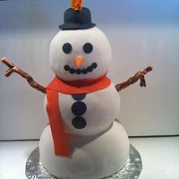 Snowman Should have put a sode bottle beside it, this cake is about 2 feet high! All fondant except the arms, which are tootsie rolls.