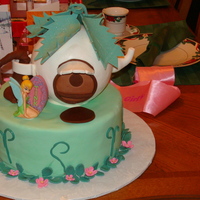 Tink's Teapot Townhome From the Wilton catalogue. We tilted the teapot too far forward, but otherwise it's ok. For a 5 yr old girl's bday party. Tink is...