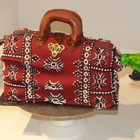 Mary's Carpet Bag The Super Nanny of All Nannies carpet bag. Rich dark chocolate cake with raspberry filling. Covered in Fondant. Parrot made out of Fondant...