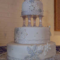 Snowflake one of my favorite cakes I have ever done. the snowflakes are all hand piped with royal frosting, then some of them painted with silver