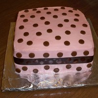 Baby Shower Buttercream with fondant dots and silk ribbon.