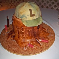 Lance's Groom's Cake I made my son a tree stump red velvet pound cake topped with a gumpaste hunting cap. All fish hooks and shells were gumpaste.