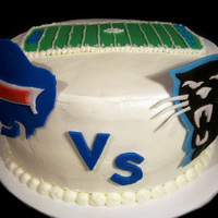 Big Football Matchup! A cake to celebrate the Bills playing at the Panthers. Buttercream frosting and for the football field, and fondant logos.