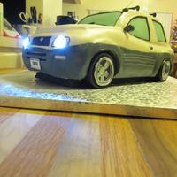 Toyota Rav4 Cake A Toyota Rav4 cake for my cousin who just turned 16. Rainbow cake, modeling chocolate, fondant. The headlights are little battery-powered...