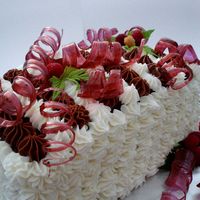 Chocolate Mousse Torte Devil's Food Cake layered with 2 kinds of mousse and fresh raspberries. The ribbons are pulled sugar, which I had never attempted...