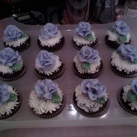 Violet Roses On Chocolate Cupcakes Practiced my buttercream icing roses and shared them with the office.