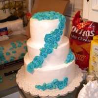 Simple White Wedding Cake With Blue Roses This is my first wedding cake I did for my sister's wedding. It's covered in white buttercream frosting and the roses are also...