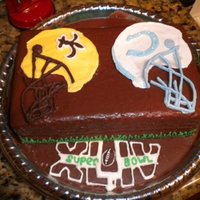 2010 Superbowl Cake The frosting is a homemade fudge frosting that I poured over the cake and it smoothed perfectly on it's own. The football helmets and...