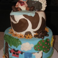 Baby Buckaroo Cowboy Shower Cake first tier is chocolate with cream cheese filling. Second tier is WASC with lemon cream cheese. All fondant decorations.