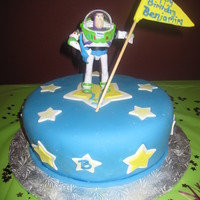 Buzzlight Year royal blue fondant, with white and yellow stars and a buzz light year topper. i made this for a 4 year old boy birthday