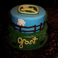John Deere Birthday Cake 8" & 10" chocolate cakes.... covered in MMF....... fondant and buttercream accents. Name is supposed to say "Grant"...