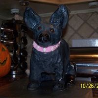 Leslie's Birthday Cake 2 9" round and 1 football carved chocolate cakes iced with buttercream icing. Head, ears, legs and tail are all rice krispy treats....