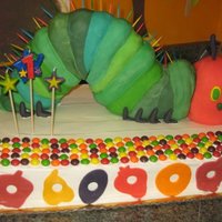 The Very Hungry Caterpillar My nephew Roman's 1st Birthday cake. The caterpillar is made of rice crispy treats and covered in fondant. Yellow cake with cannoli...