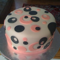 Pink N Black 8" Banana cake with chocolate mousse filling covered in fondant with fondant circle and dot cut outs.