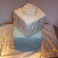 Gift Box Cake My first gift box cake, should have been a larger cake on bottom,first attempt at the quilt look as well.