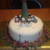 Our First Christmas Together 10" chocolate cake filled w/BC and covered in fondant. All decorations are fondant. This was a Grooms cake for a Winter Wonderland...