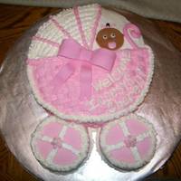 Baby Carriage Cake Yellow cake with butter cream icing. fondant face and carriage handle. This was for a little girl's baby shower