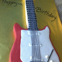 Guitar Cake Yellow cake covered in fondant. This is a 2D cake covered in fondant.