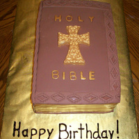 Antique Style Holy Bible Cake This is a yellow cake with fondant and chocolate accents. The cross, text, and page edges are painted in gold luster dust.