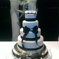 Snowflakes, Ribbons, And Pearls This is a four tier bridal shower yellow cake. White fondant with snowflake impressions and jazzed up with pearl dust. black satin ribbon...