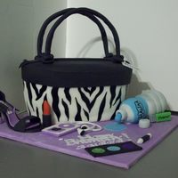 Zebra Purse Cake Yellow cake with chocolate filling, covered in butter cream. Cake is covered in fondant with painted stripes. Water bottle made from rice...