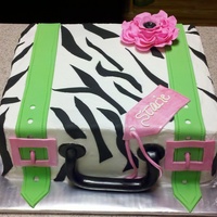 Zebra Suitcase I made this cake for a going away party for a client. The icing is homemade buttercream. The details are MMF and the flower is Gum Paste.
