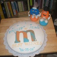 M&m's Groom Cake This is the main cake out of a 4peice Groom's cake display. All cake's are covered in fondant and have a gumpaste M&M figure...