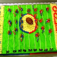 Kids Football Cake Football cake, fully piped. Bear crackers for players and choco-covered pretzels for goal posts