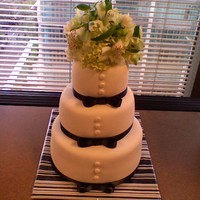 Black And White Tuxedo Cake Three tiers (10,8,6) and real flowers on top. Fondant covered with fondant buttons dusted with pearl luster dust. Irish cream cake and...