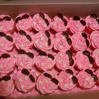 Minnie Mouse Themed Cupcakes Vanilla buttercream icing in pink with whit polka dots, ears are mini oreos with inside scraped off.