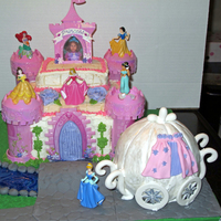 Disney Princess Cake Disney princess castle cake with princess carriage, cobblestone path and bridge, and moat.