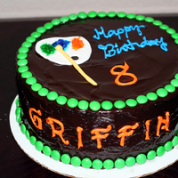 Griffin's Birthday Cake 9" round with chocolate fudge cake and chocolate ganache and M&M border. Paint palette and paint brush made of fondant/gum paste...