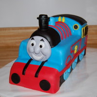 3D Sculpted Thomas The Tank Engine 1/2 vanilla, 1/2 chocolate cake, vanilla buttercream frosting & covered in buttercream fondant. All decorations are fondant.