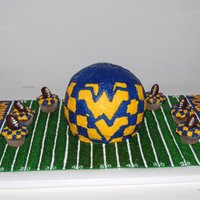Wvu Birthday Chocolate fudge cake covered with buttercream. Field is buttercream. Mini chocolate cupcakes w/ homemade Oreo football truffles.