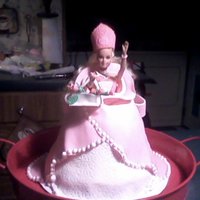 Barbie Cake Barbie with white dress with imprint with a shoulder shroud gown carrying a basket of pink calla lilies. A lot of fun to make!