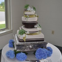 Nature Themed Wedding Cake Wired gum paste flowers, chocolate fondant ribbon borders, fondant bows.