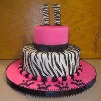 Zebra Print Cake Cake for my daughters 11th birthday. Used 10 and 6in rounds, both chocolate cake and buttercream, and all MMF decor. A few mistakes but fun...