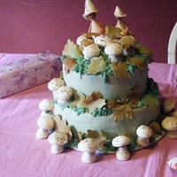 Fall Baby Shower Cake This is a MMF covered cake with fondant leaves, meringue mushrooms and gumpaste fairies.