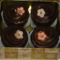 Holiday Flower Cupcakes Chocolate cupcakes with cream cheese filling and chocolate cream cheese frosting. Decorated with handpainted sugarpaste (gumpaste) flowers...