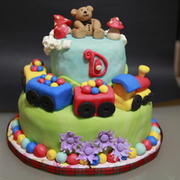 Chu Chu Bottom tier 9" Lemon cake, top tier 6" white chocolate cake, both with buttercream frosting, fondant finished and figures.