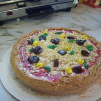 Pizza Maybe not the prettiest I've ever come up with but I had to try it. Orange cake with orange frosting, cheese is coconut and white...